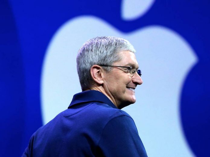 Tim Cook-smiling-Apple logo