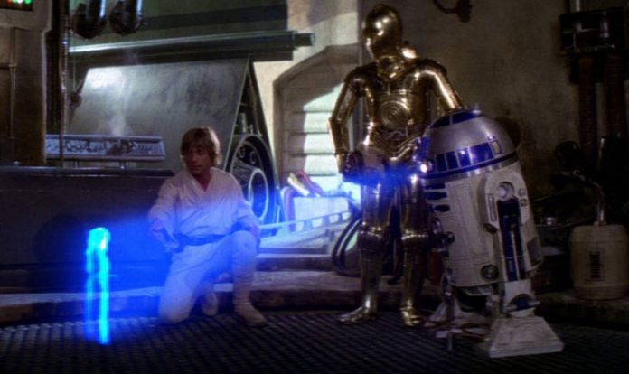 Luke-Skywalker-and-C-3PO-watch-R2-D2-display-a-hologram-of-Princess-Leia-in-Star-Wars-A-New-Hope