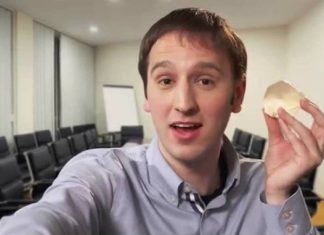 Steve Keating holding a 3D print of his brain tumor.