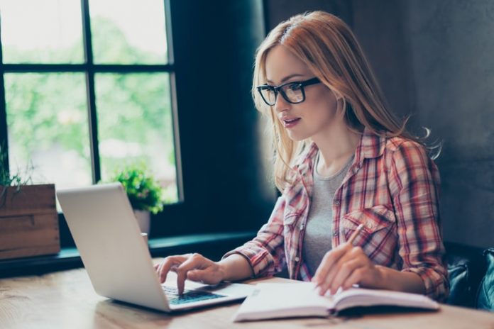 Young Woman Writing Dissertation