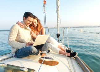 Young Couple Sailing On A Boat