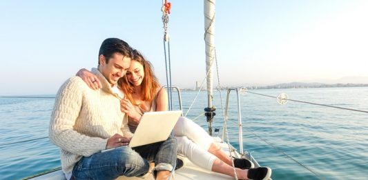 Young Couple Sailing On A Boat