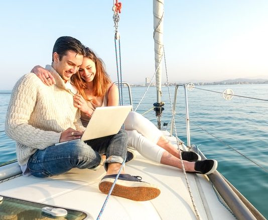 Young Couple Sailing On A Boat