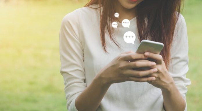 Woman Using Live Chat on Mobile Phone