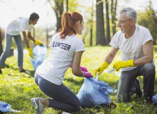 Two Volunteers Picking Up Garbage